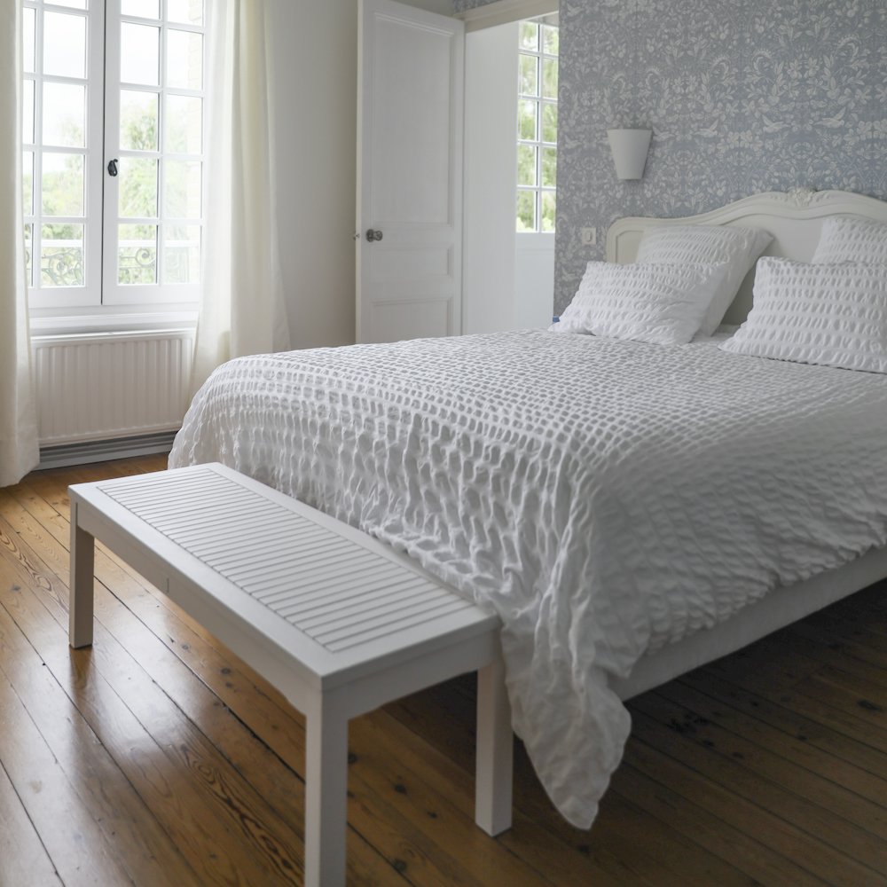 Double bed with white linen