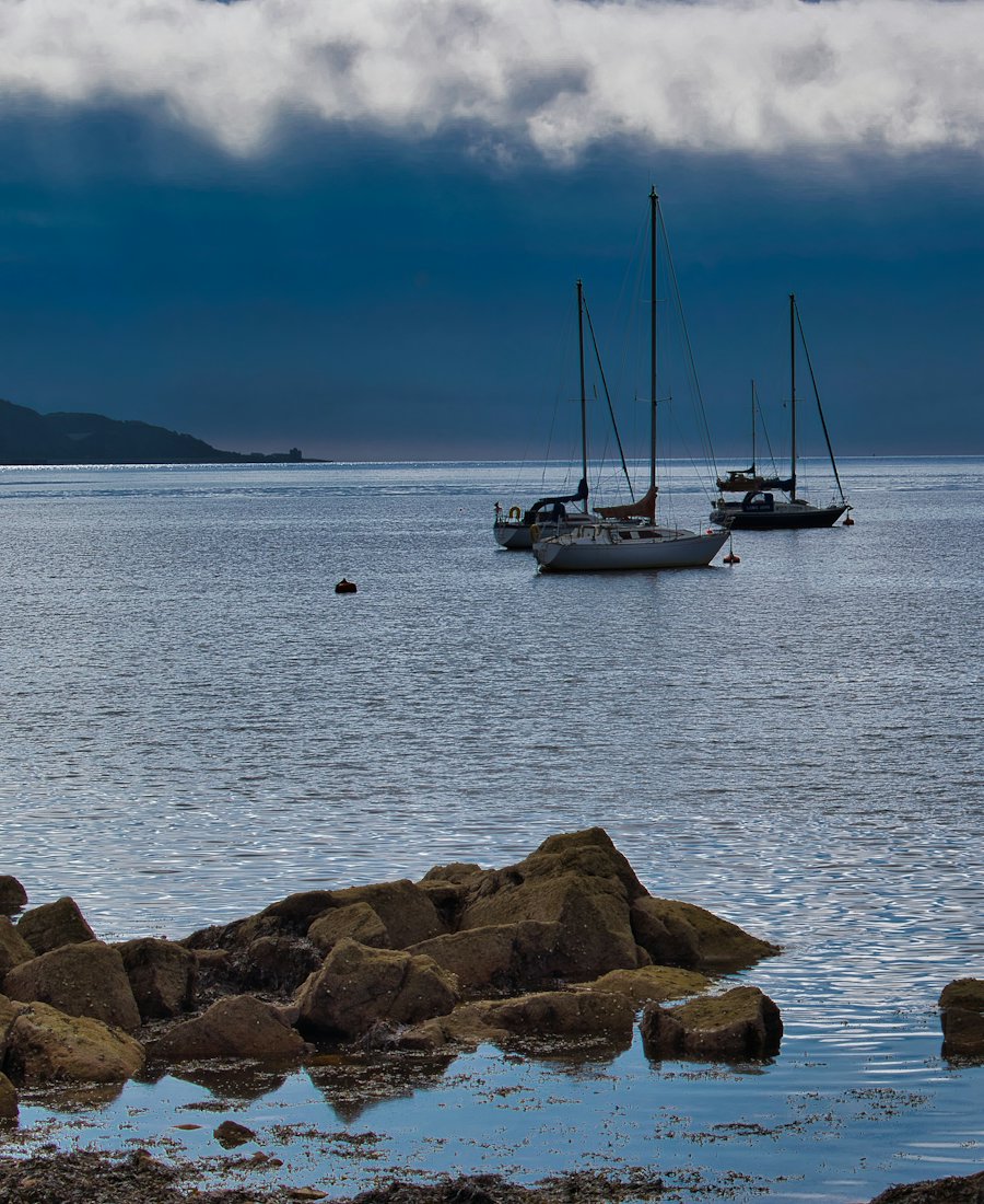 Sailing boats moored in a calm bay